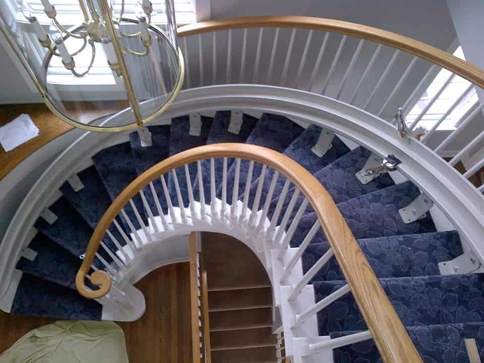 a curved staircase with a lift